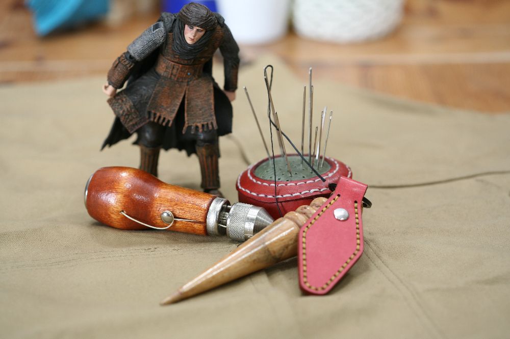 Handcrafted leather keyring with detailed stitching, available in brown and other colours