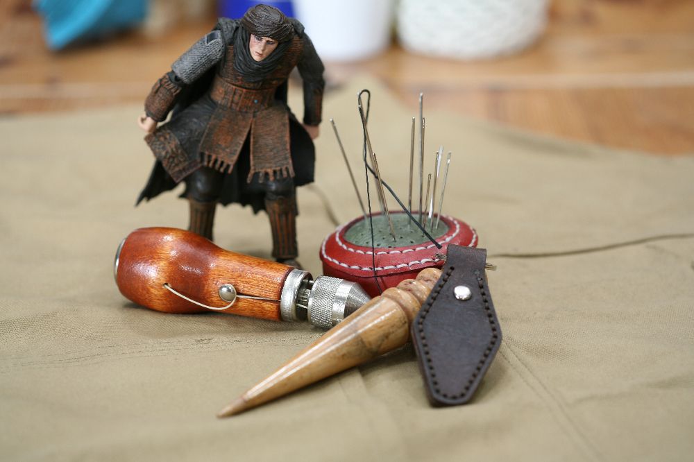 Handcrafted leather keyring with detailed stitching, available in brown and other colours